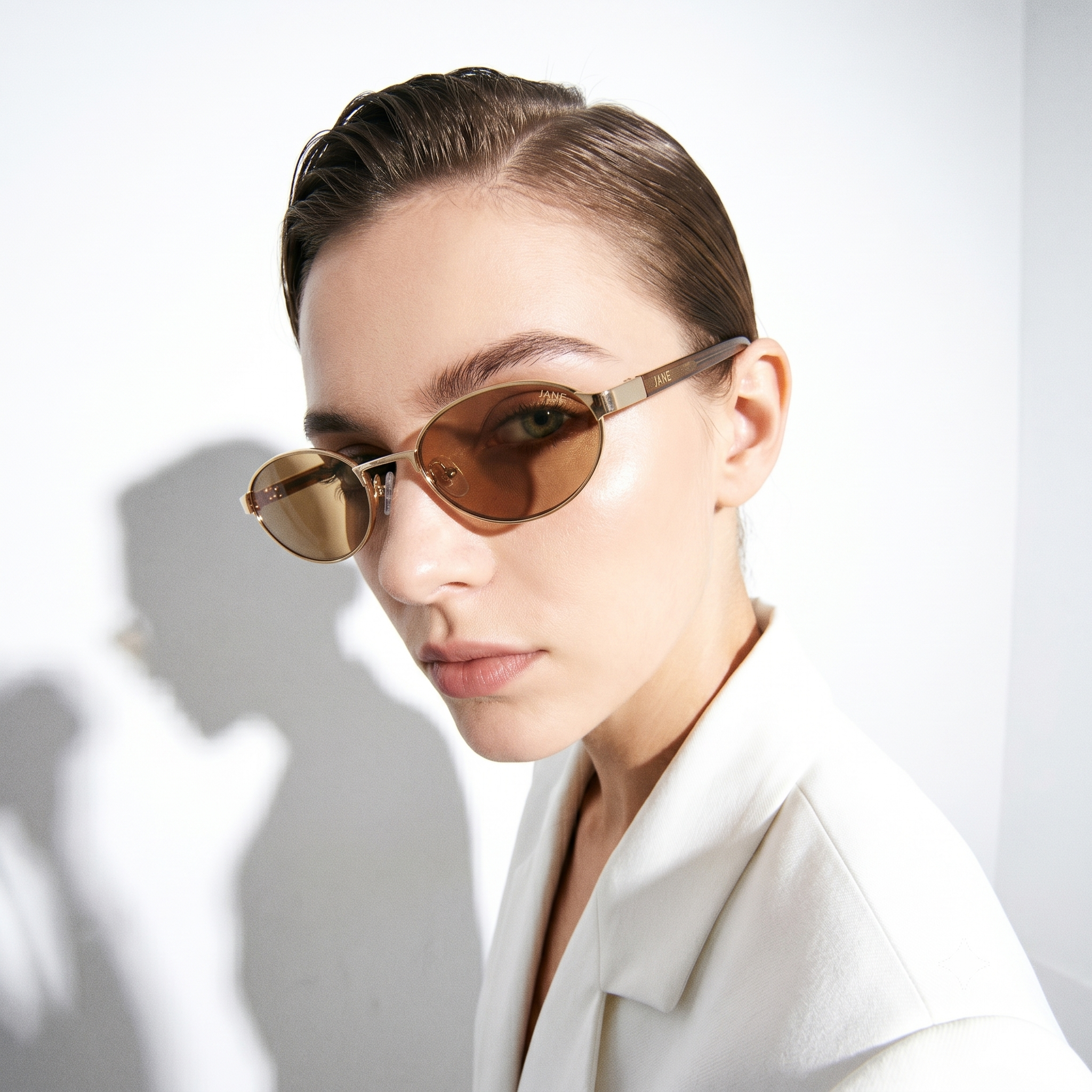 Woman wearing sunglasses with a white background