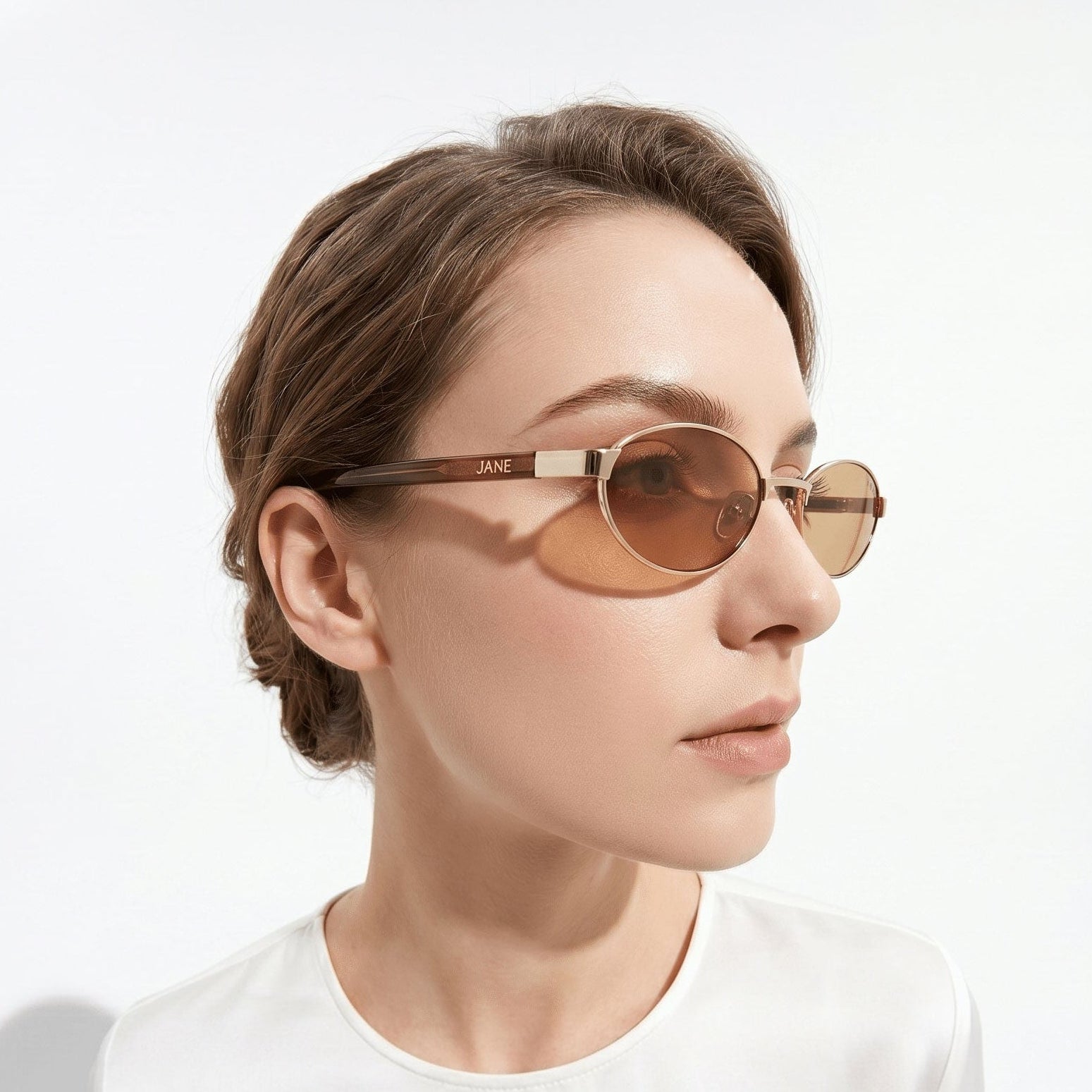 Person wearing round sunglasses with a neutral background