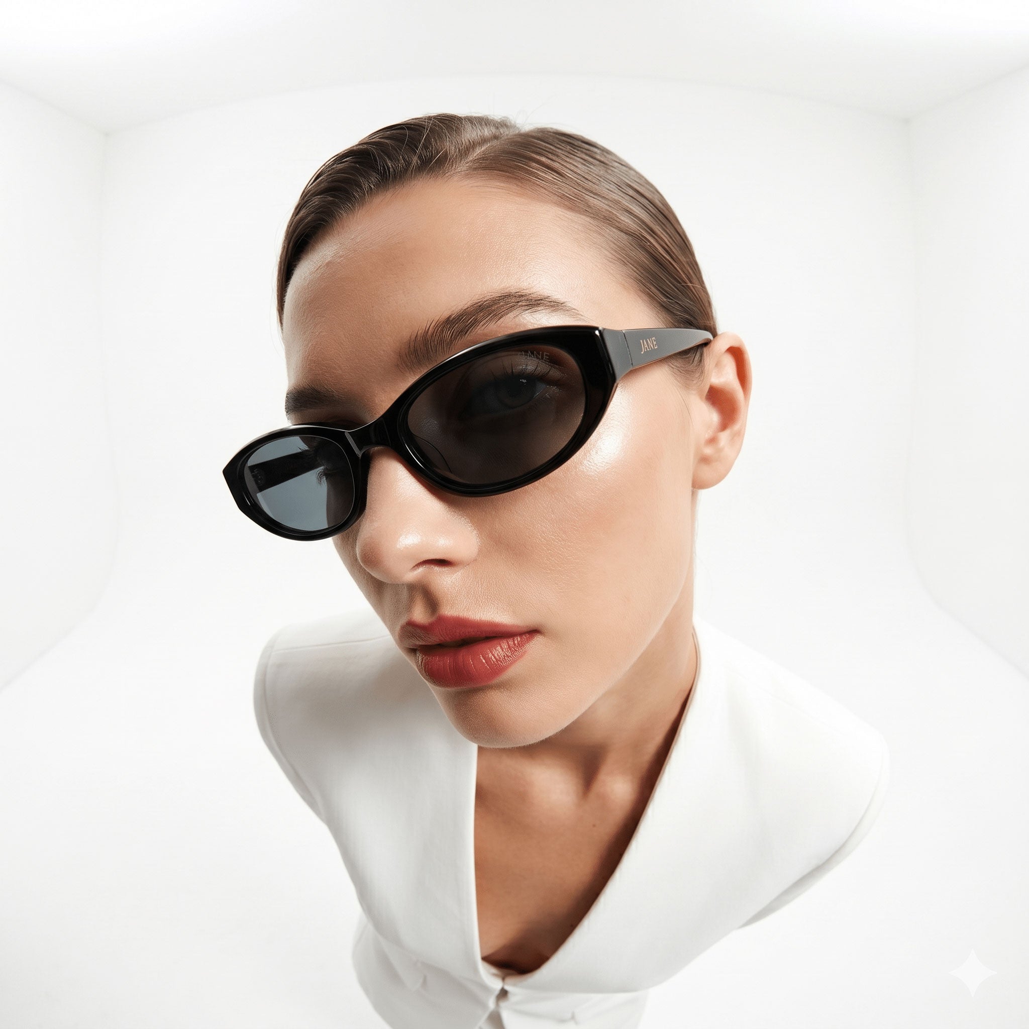 Woman wearing black sunglasses with a white background